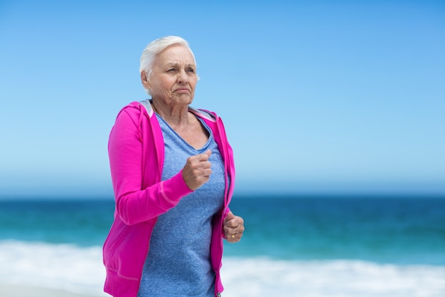 Focused mature woman running