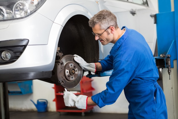 Focused mechanic adjusting the wheel