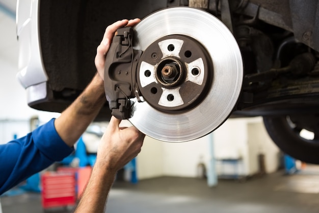 Photo focused mechanic adjusting the wheel