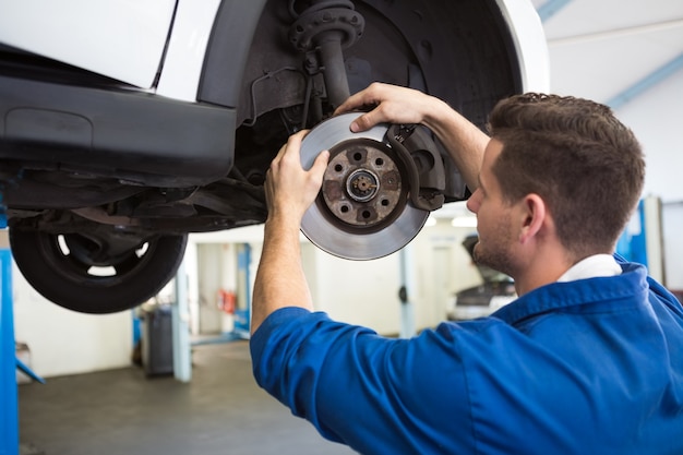 Focused mechanic adjusting the wheel