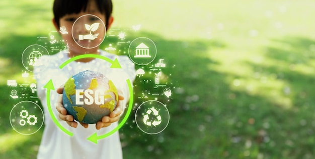 Focused planet Earth globe with eco friendly icon hold by blur little boy symbolize environmental protection for future generation with ESG effort and green sustainable technology Panorama Reliance