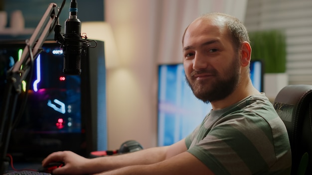 Premium Photo Focused streamer gamer looking at camera preparing streaming space shooter online video game playing on rgb powerful computer during egames championship