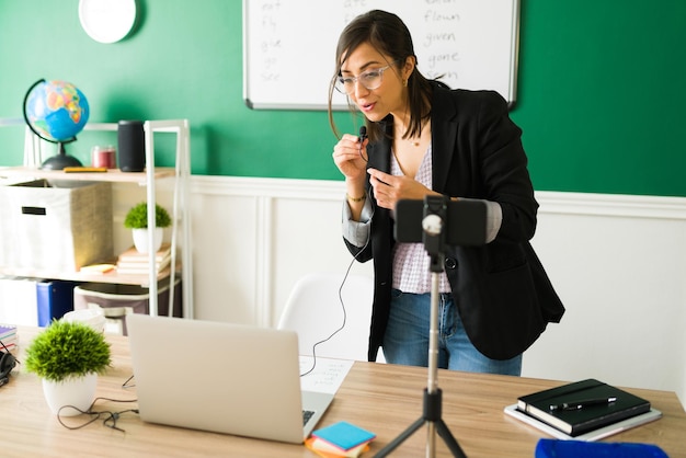 Focused teacher talking to her students and telling to pay attention during an online lesson through a video call