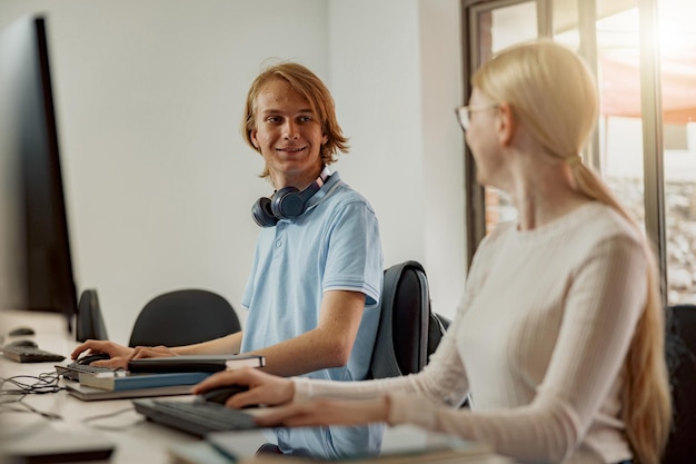 Focused university student using computer studying in computer room