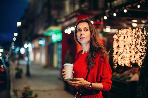 Focused woman looking to distance in evening city