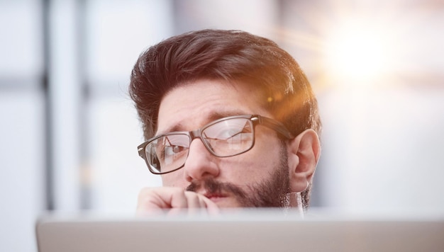 focused young businessman looking at computer monitor