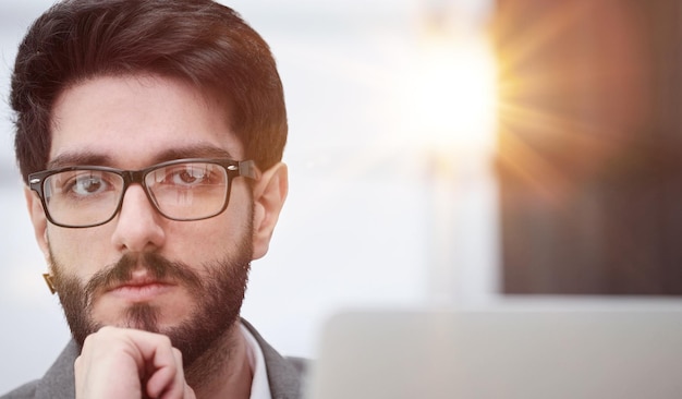 focused young businessman looking at computer monitor