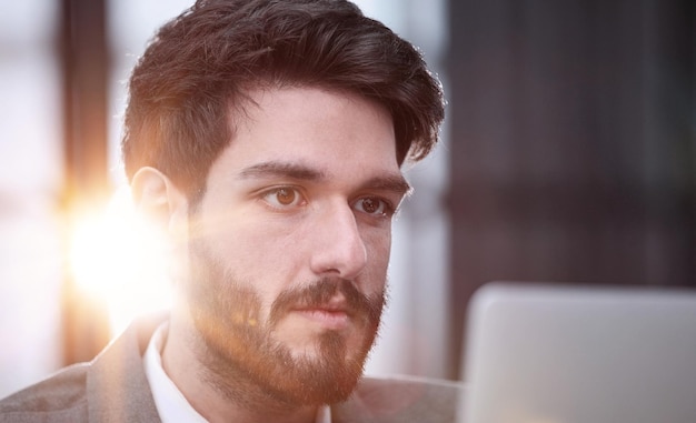 focused young businessman looking at computer monitor