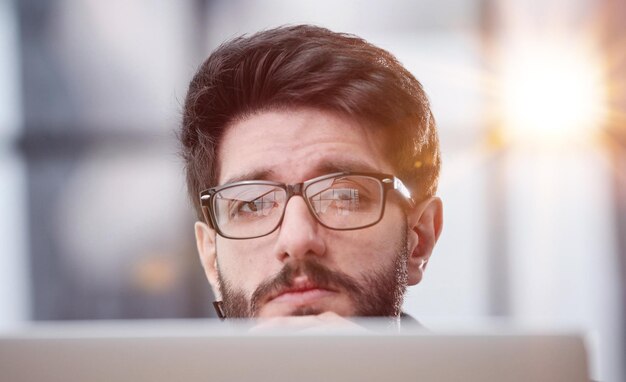 focused young businessman looking at computer monitor