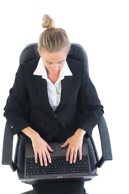 Focused young businesswoman sitting on an office chair