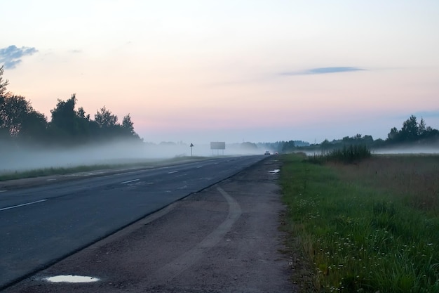 Fog on a country road at sunset