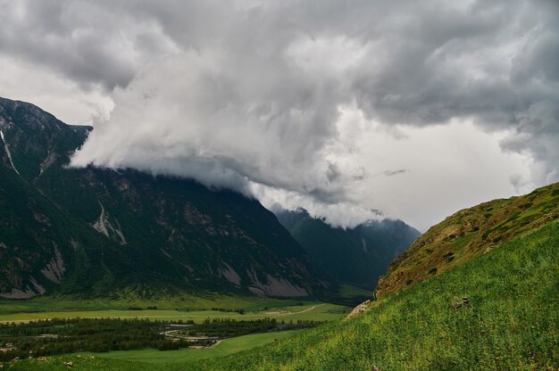 Fog in the mountain valley. Morning fog over the lake in the Altai mountains.