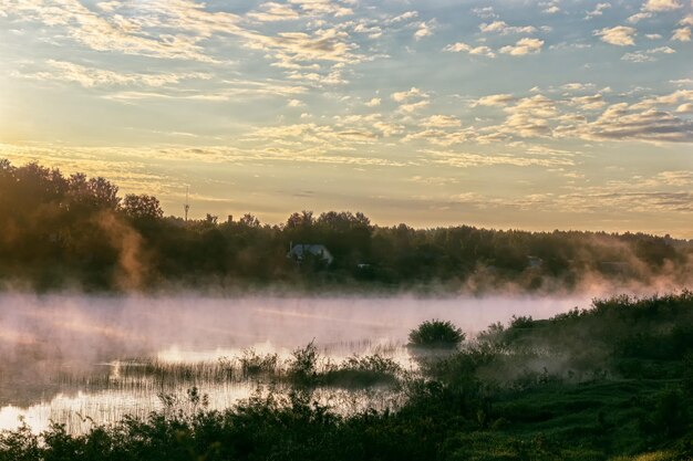 Fog over the river and the rising sun Colorful view of the river