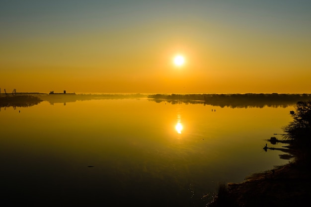 Fog above the water surface Sunrise at the river Dnieper in Kremenchug Ukraine