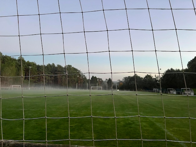 A foggy football field Low angle of the green grass of a football field Concept of a sports field