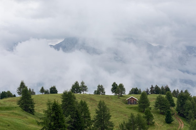 Foggy landscape on the hills in the Italian Alps