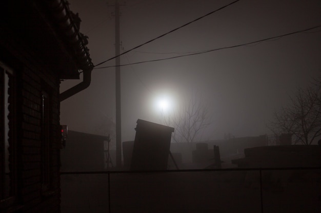 Foggy night and moonlight in the village