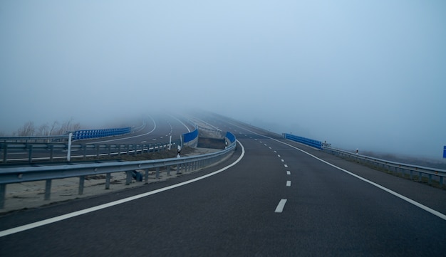 Foggy road with fog in horizon