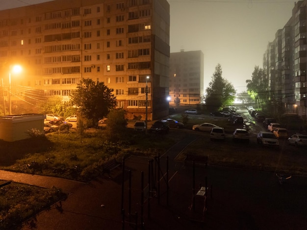 Foggy summer night in russian suburban condo street