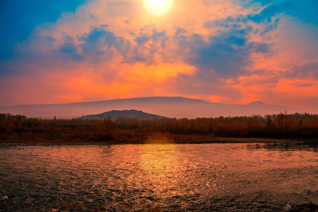 Foggy sunset over mountain river