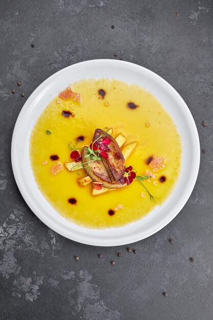 Foie gras with sauce, on a white plate