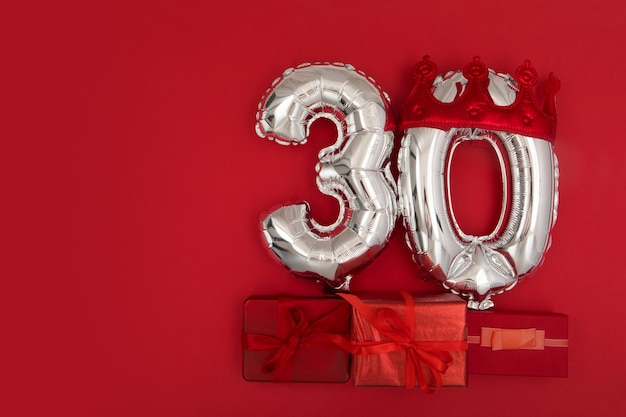 Foil balloons with number  on red background