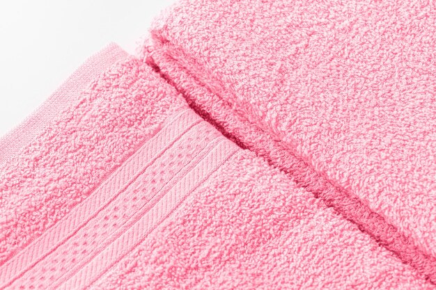 Folded bath sheet or towels in color of the year 2023 Viva Magenta Closeup of texture copy space