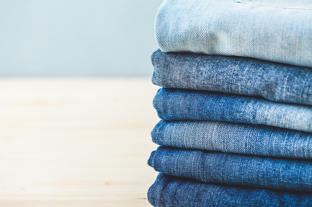 Folded blue jeans on a light background Copy spase