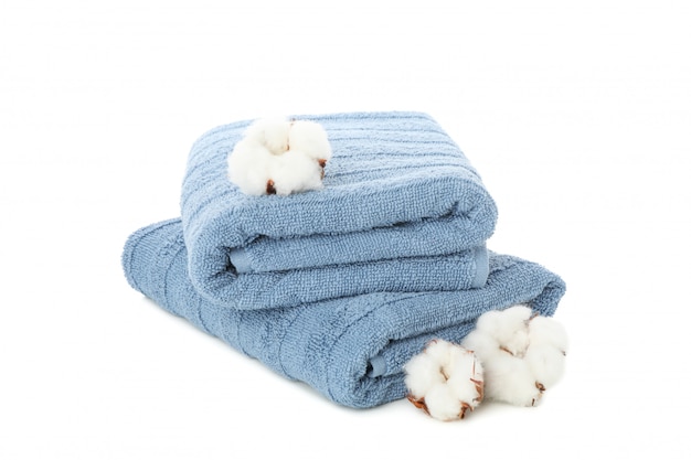 Folded blue towels and cotton isolated on white