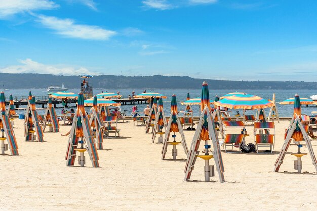 Folded deck chairs and beach umbrellas on sandy beach