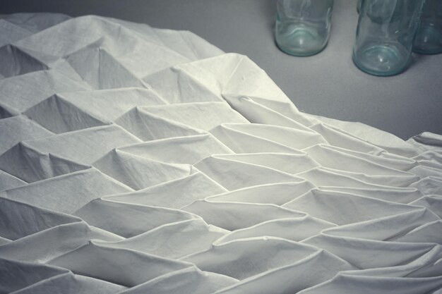 Photo folded fabric by drinking glasses on table