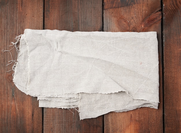 Photo folded gray linen towel on wooden surface