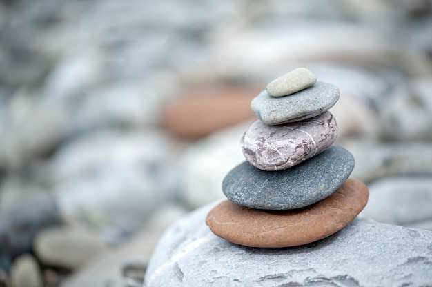 Folded pyramid of smooth stones on the seashore