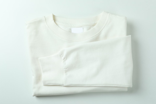 Folded sweatshirt on white surface