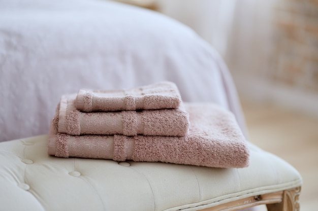 Folded towels on the bed in the room.