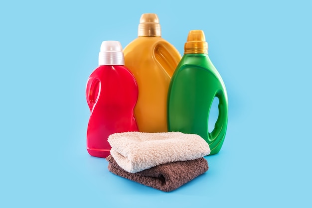 Folded towels with washing and rinsing gel on a blue background.