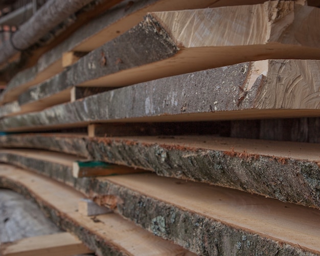 Folded wooden planks in a sawmill. Piled boards as texture.