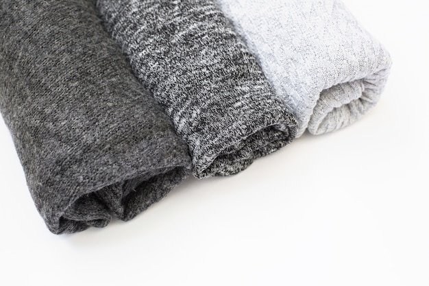 folded wool sweaters with different knitting