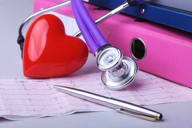 Photo folder file, stethoscope, red heart and rx prescription on the desk