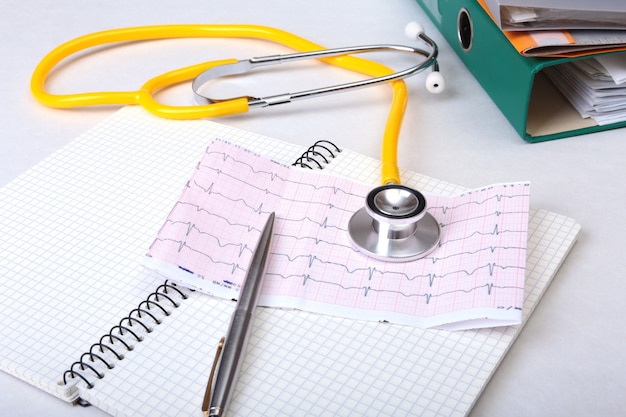 Folder file, stethoscope and RX prescription on the desk