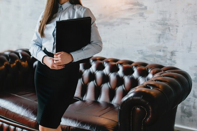 A folder in the hands of a lady businessman with a place for text. Banner