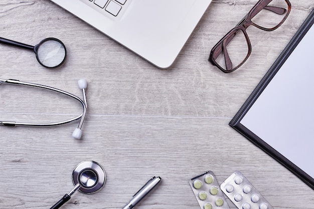 Folder, pills, loupe and glasses. Medical tools and empty space.