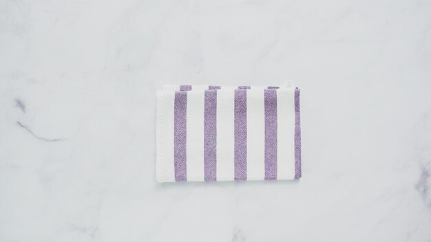 Фото Складывание синих и белых бумажных полотенец с рисунком на мраморной поверхности.