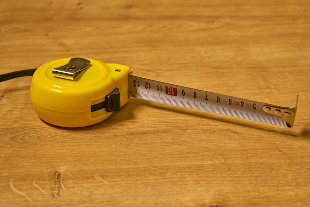 A folding rule on a wooden surface.