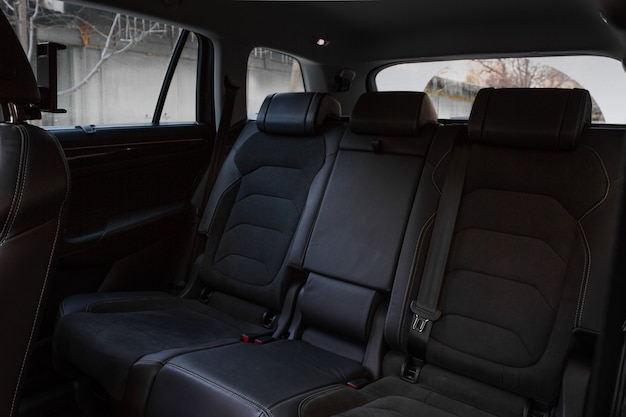 Folding seats and a cargo space inside suv car. Modern car interior. Huge, clean and empty car trunk.