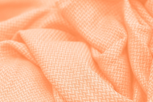 Photo folds of clothes close up concept color of the year 2024 peach fuzz