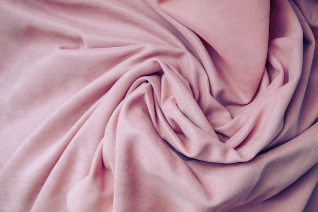Folds of pink fabric abstract background