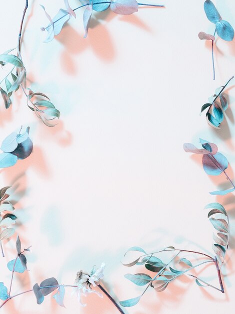 Foliage layout. Creative inverted colors design. Blue stems frame on pink