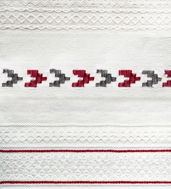 Folk handmade embroidery, embroidered ornament on white fabric, fabric decor, home textiles