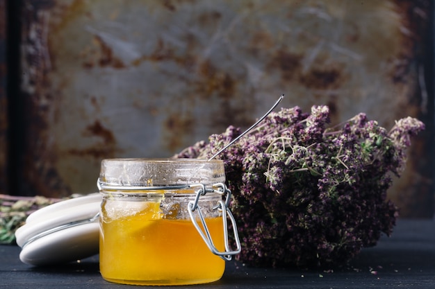 Folk medicine with honey and healing herbs concept